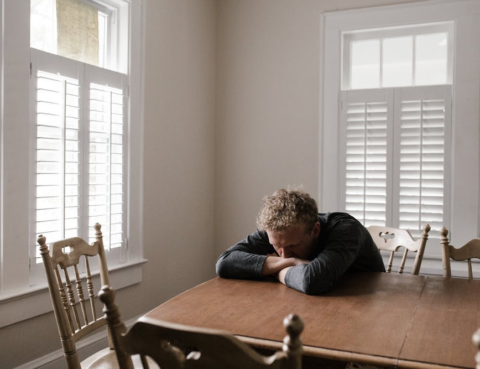 Man-stressed-table-sitting