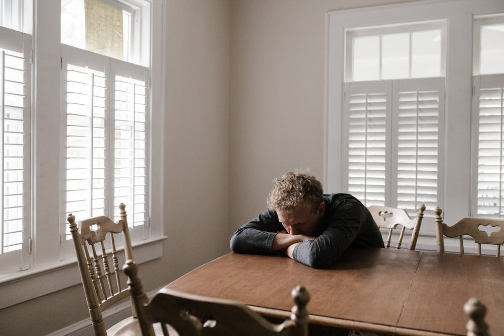 Man-stressed-table-sitting