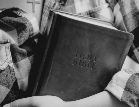 A girl holding Bible