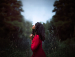 woman-praying-in-a-red-dress