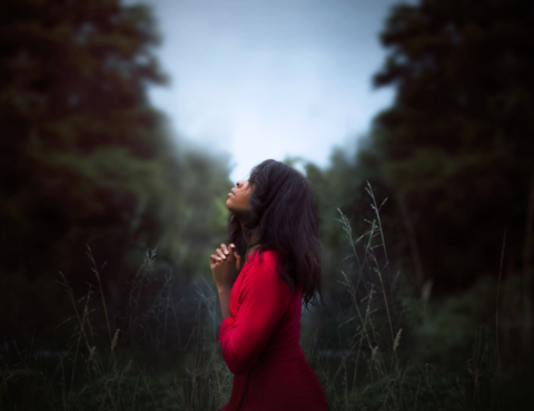 woman-praying-in-a-red-dress